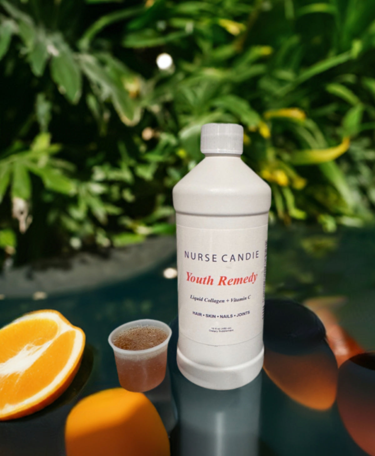 Nurse Candie Youth Remedy bottle with oranges on a reflective surface